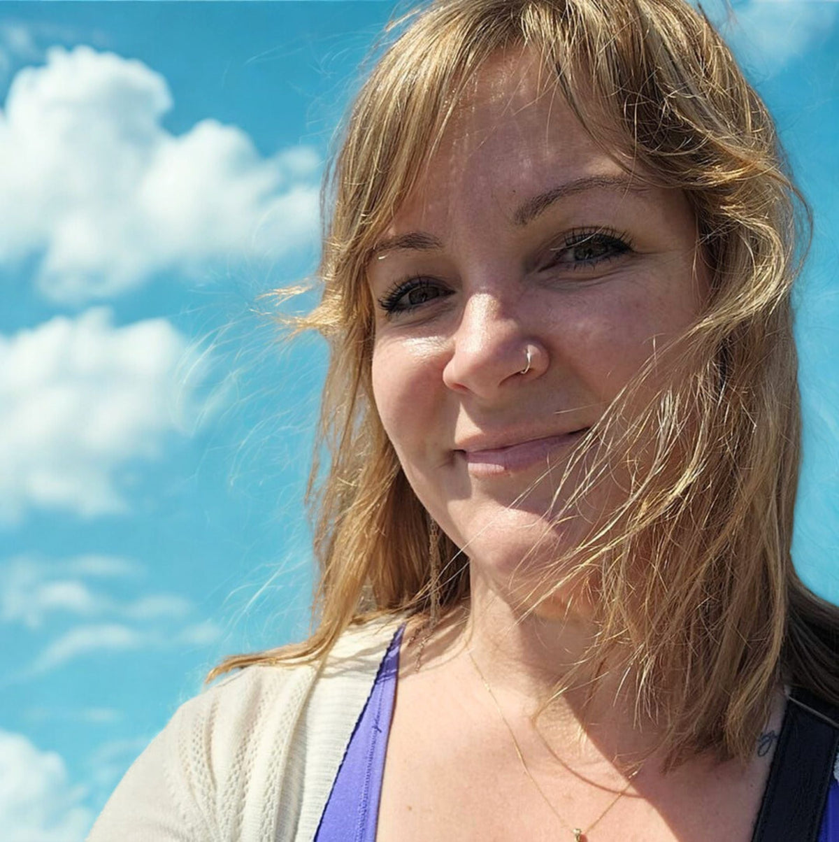 photo of Holly Smee, Artist, smiling on a sunny day with blue sky