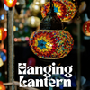 Colorful mosaic hanging lantern with blurred lights in the background