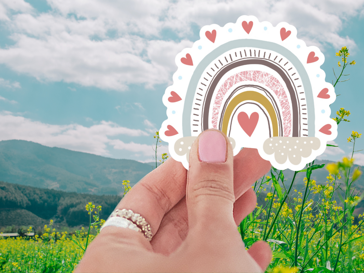 Heartfelt Rainbow Sticker against a colorful background, demonstrating its waterproof and durable design, perfect for everyday use.