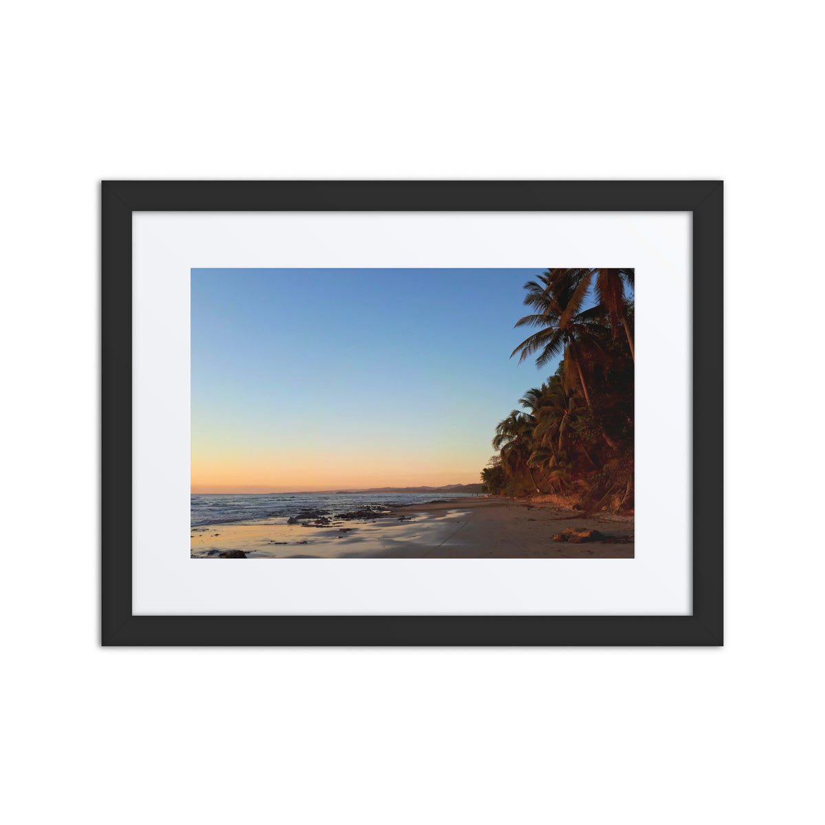 Framed artwork of a tropical beach scene with palm trees and sunset.