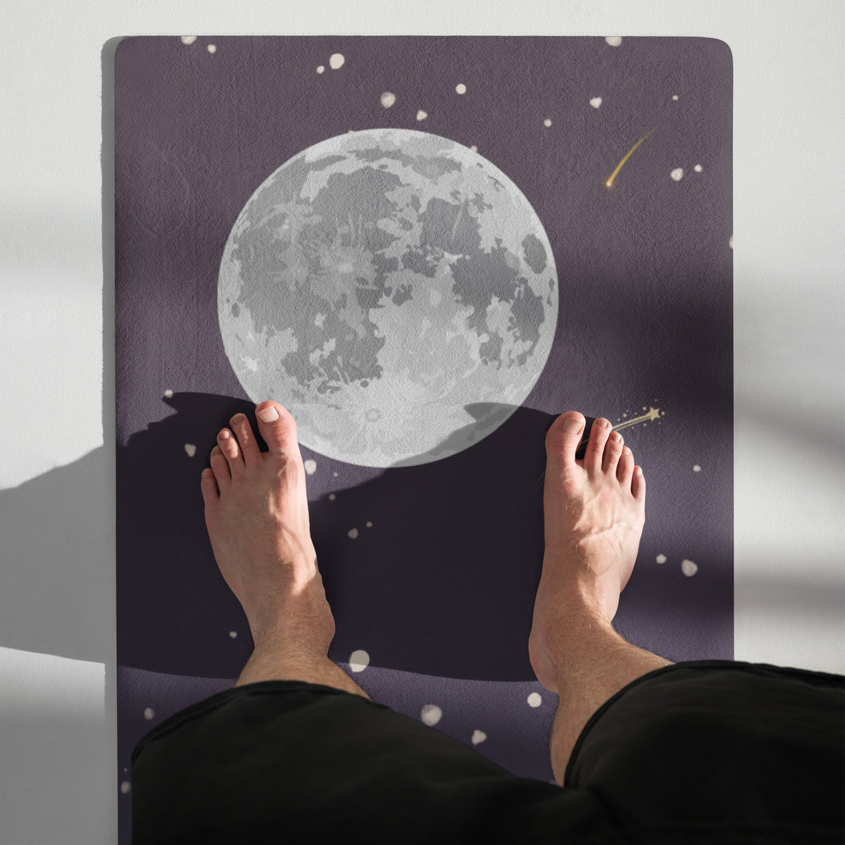 Meteor shower yoga mat featuring a full moon design with falling stars, shown in use with feet positioned on the mat.