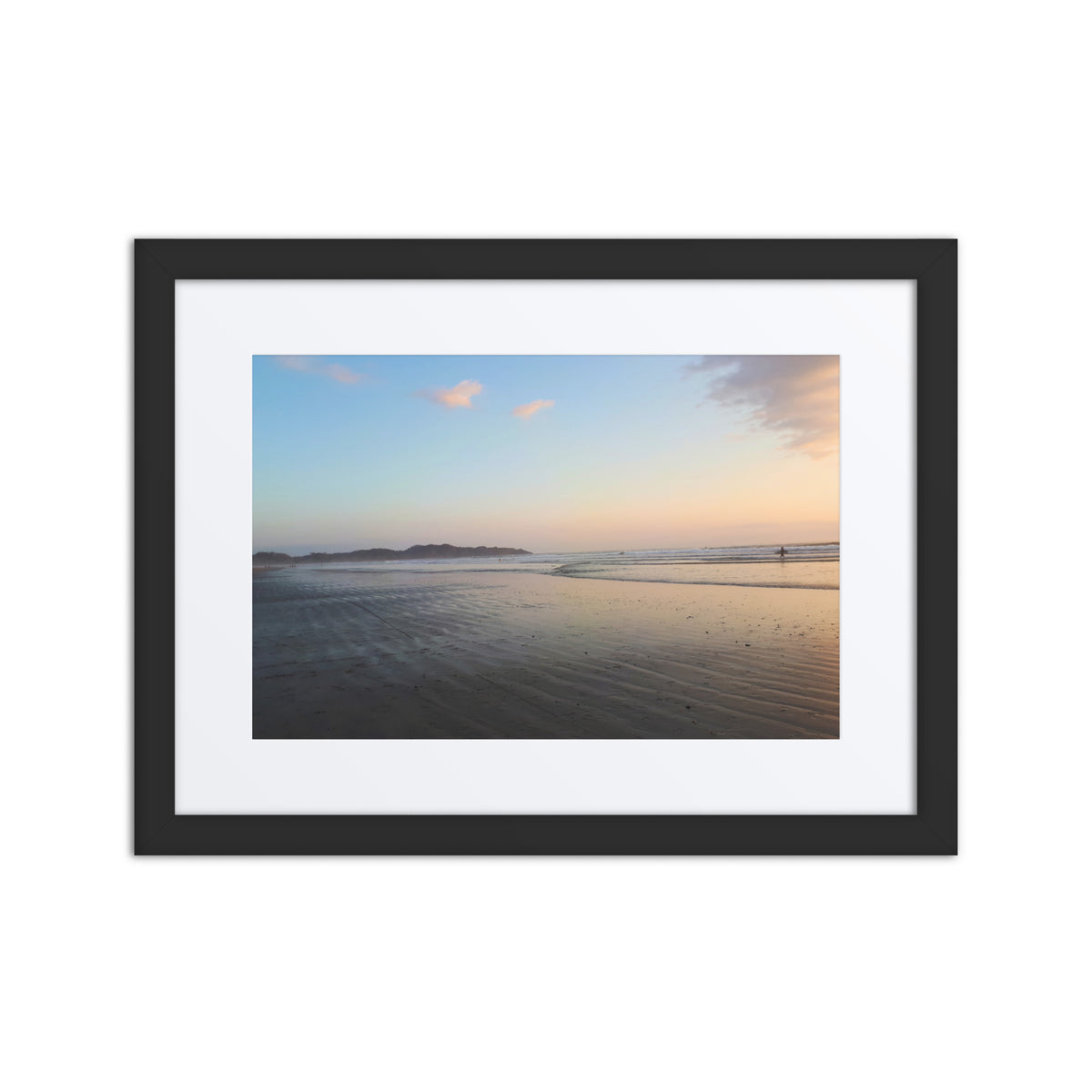 Framed artwork of a beach scene with a sunset over water.