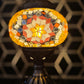 Golden Star Turkish Mosaic Lamp illuminating a reading nook, creating a warm and inviting atmosphere.